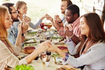 44666564-group-of-young-friends-praying-at-thanksgiving-table